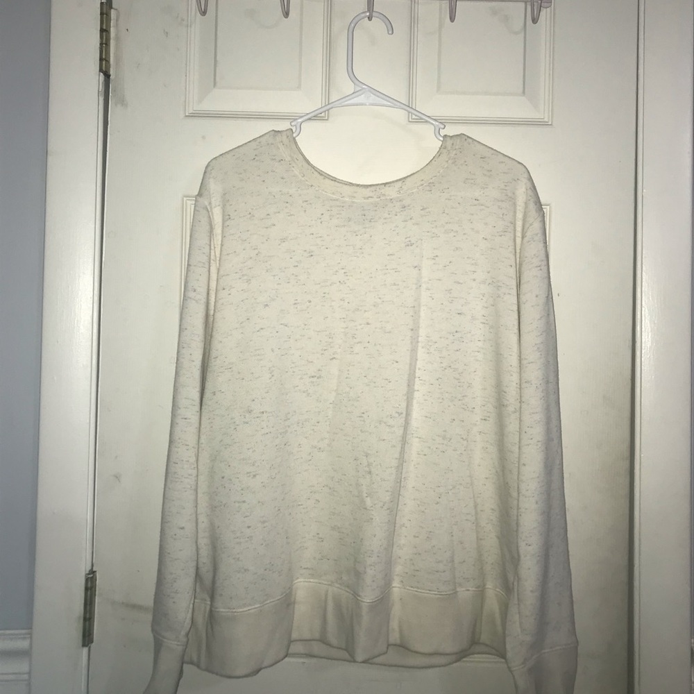 cream colored sweatshirt with touches of color